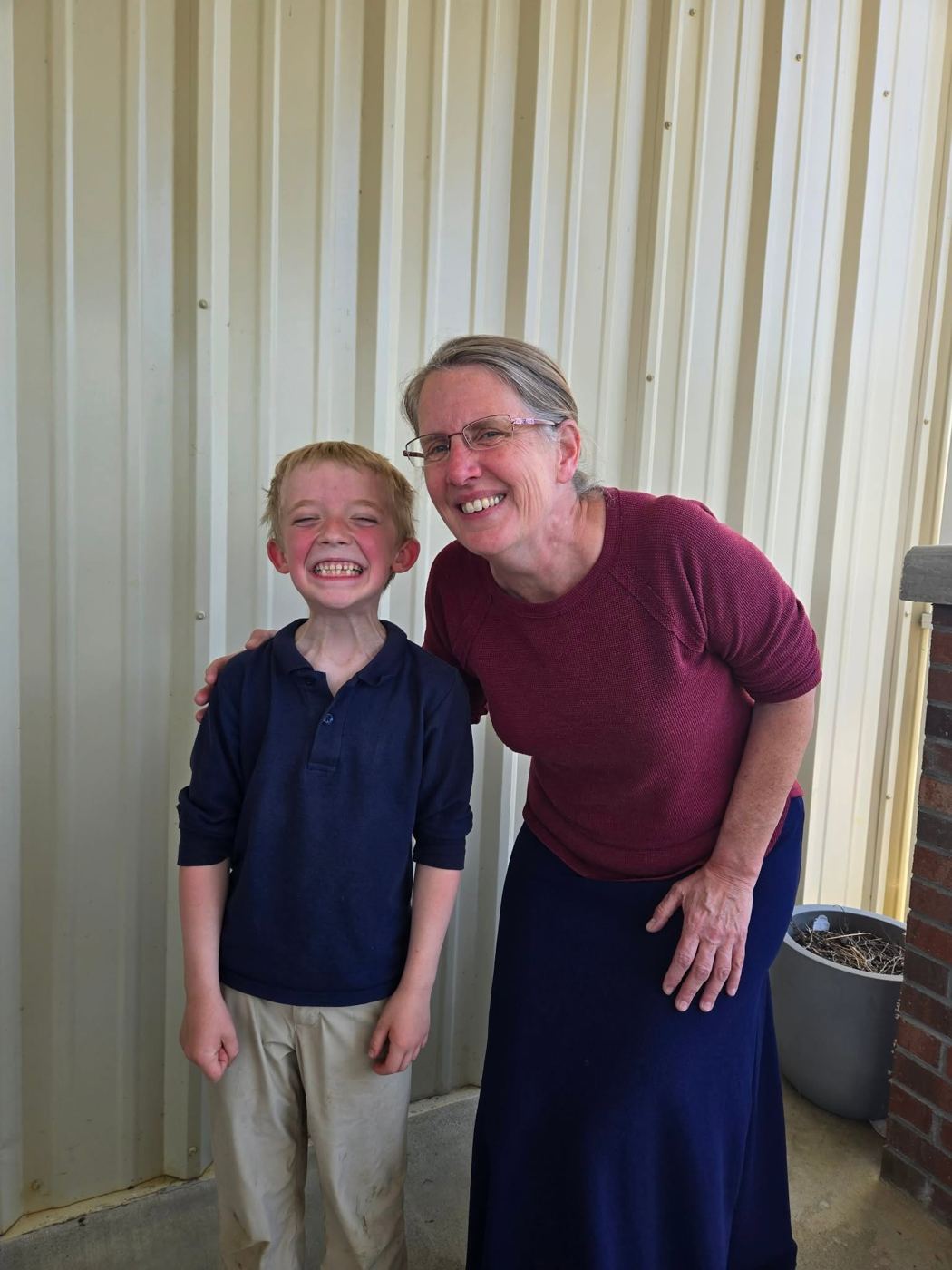 A student and teacher smiling together