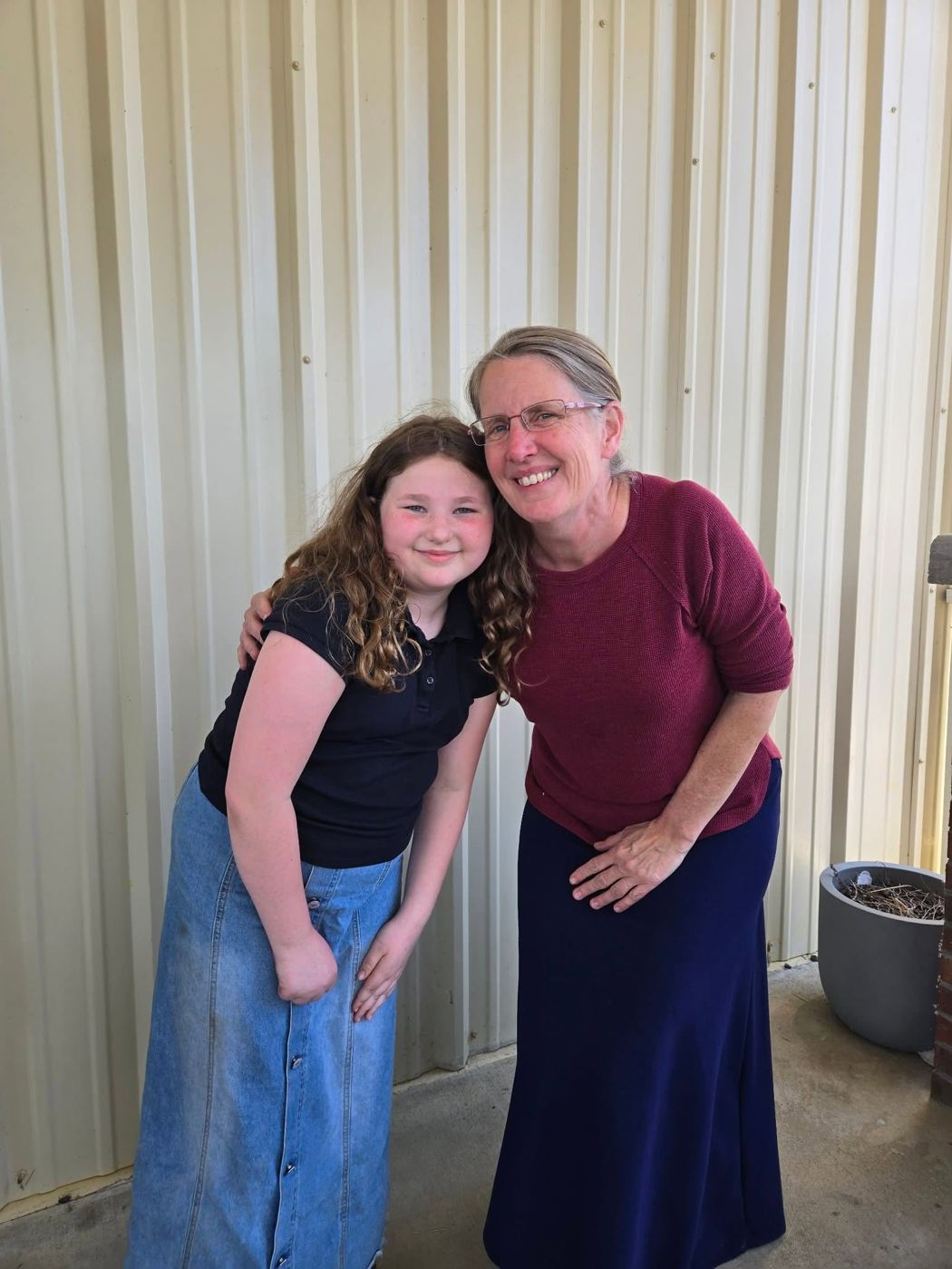 A student with her teacher, arm in arm
