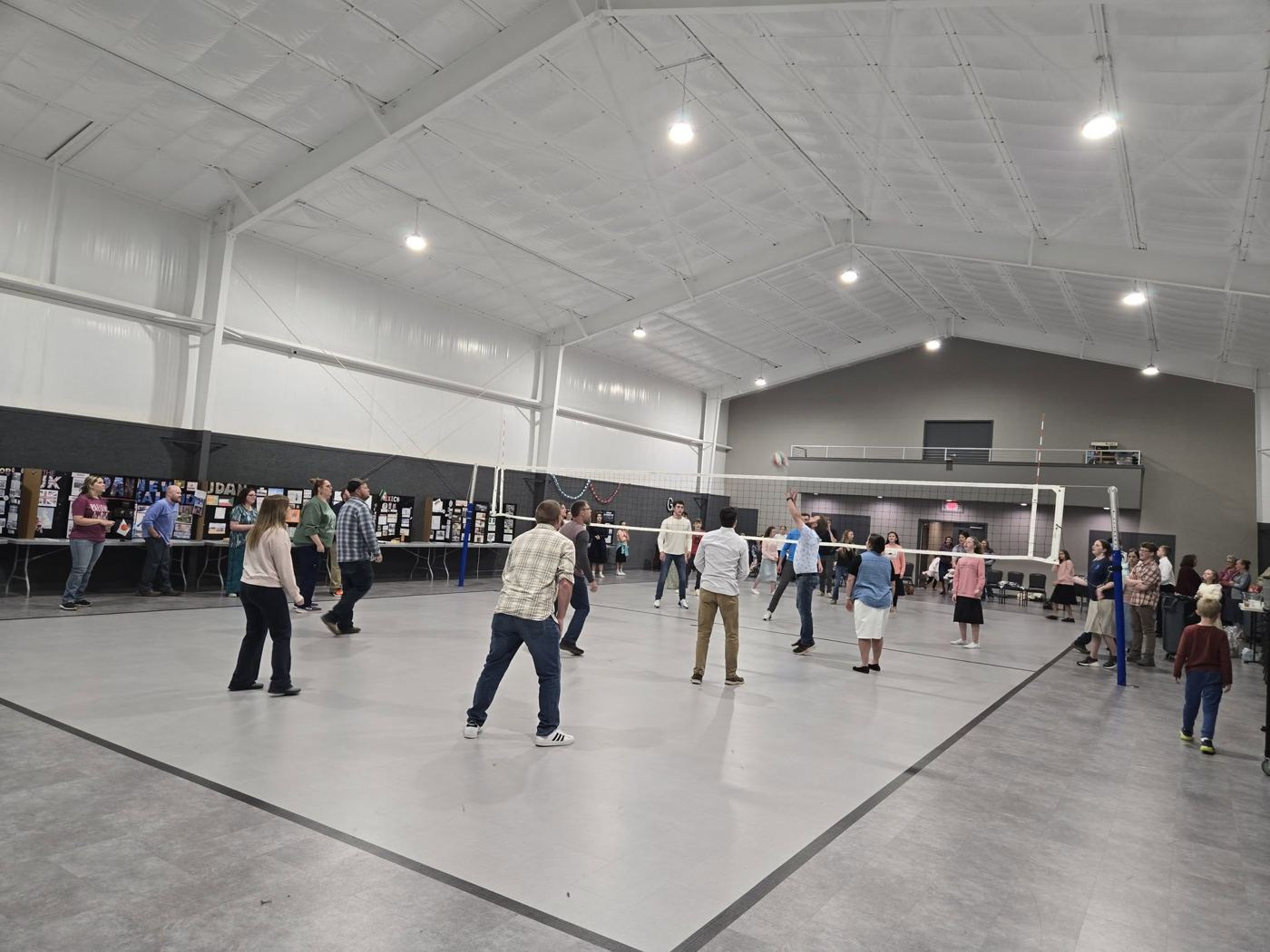 Volleyball game in the school gym with families watching